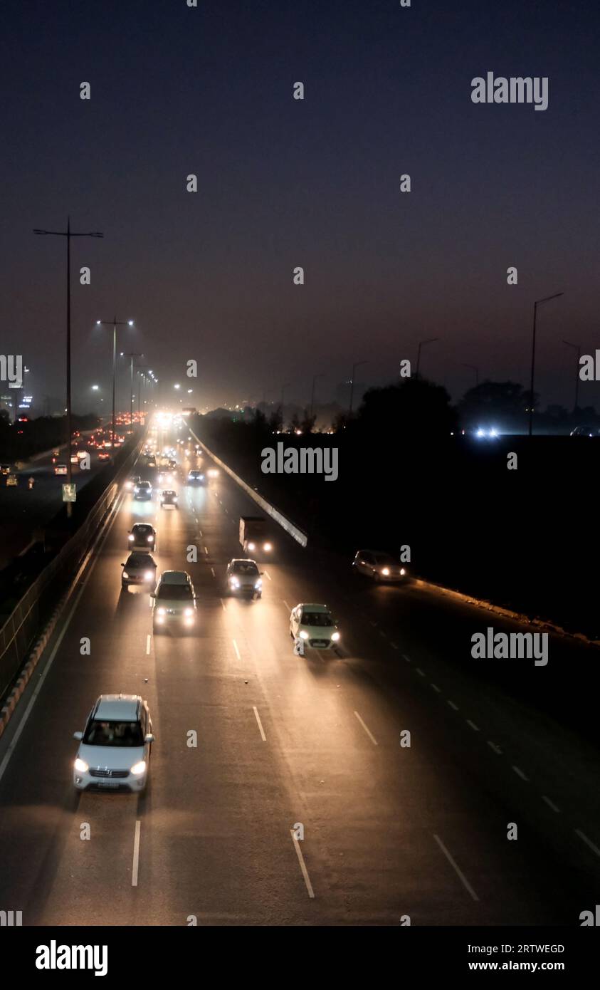 Traffic at night in Gurugram, Haryana, India Stock Photo