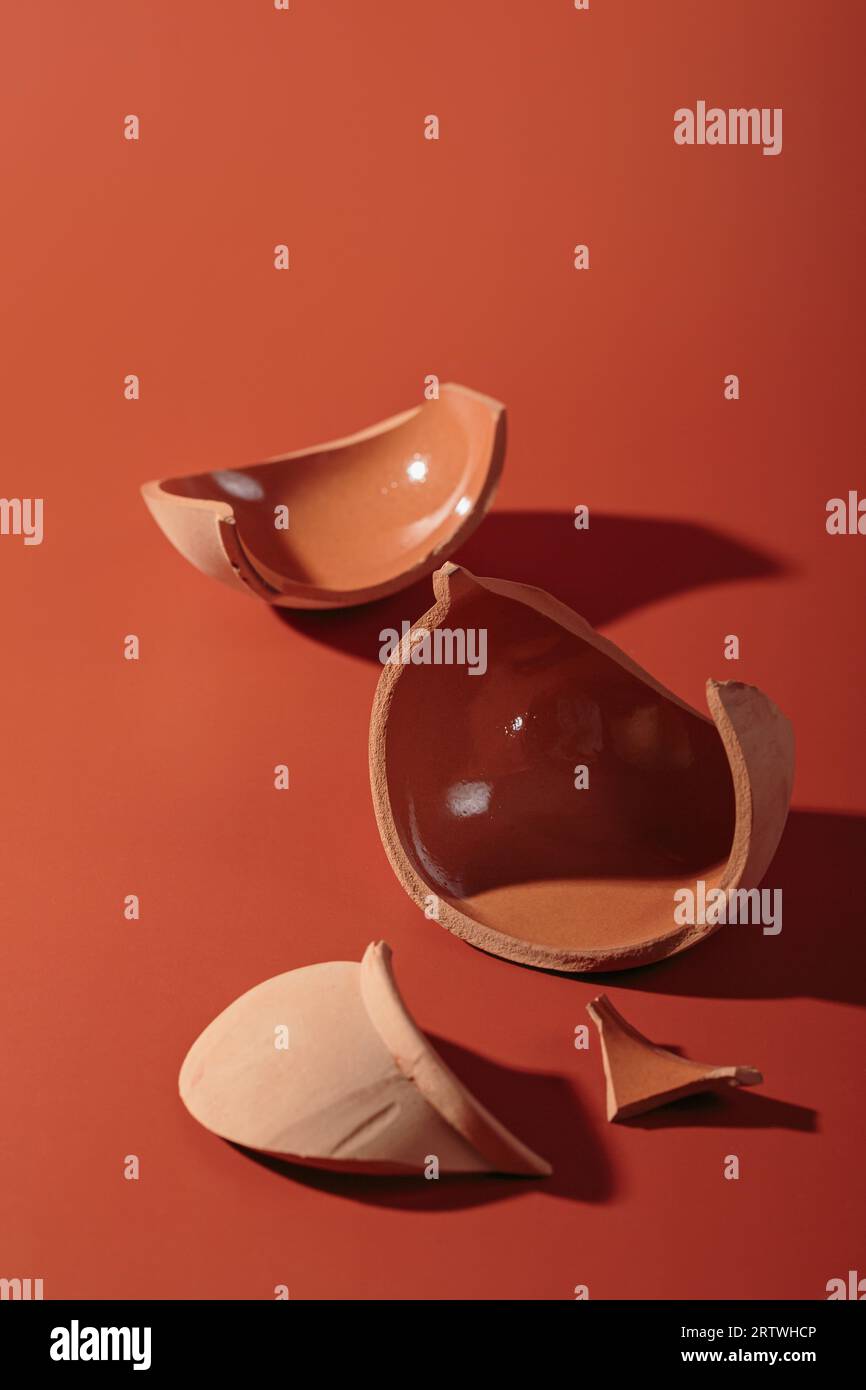 Details of broken ceramic cup on red background Stock Photo Alamy