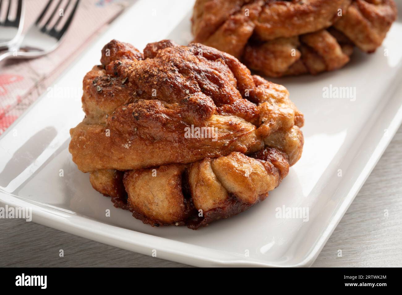 Pair of fresh homemade cinnamon rolls on a plate close up Stock Photo