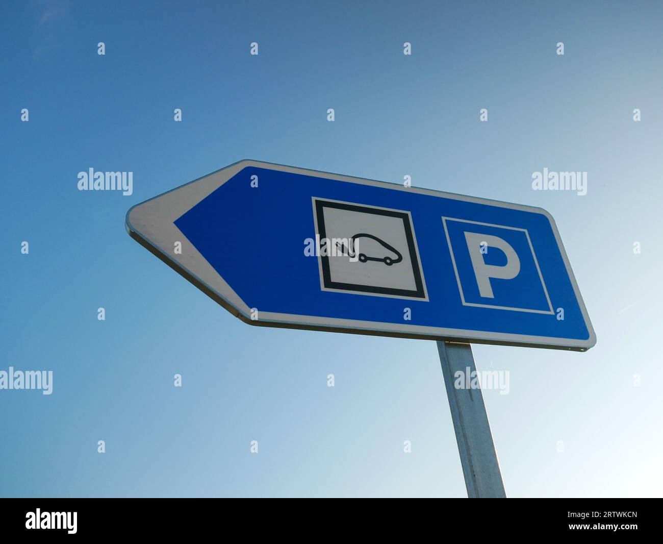 Electric vehicle charger arrow on outdoor parking, concept of high
