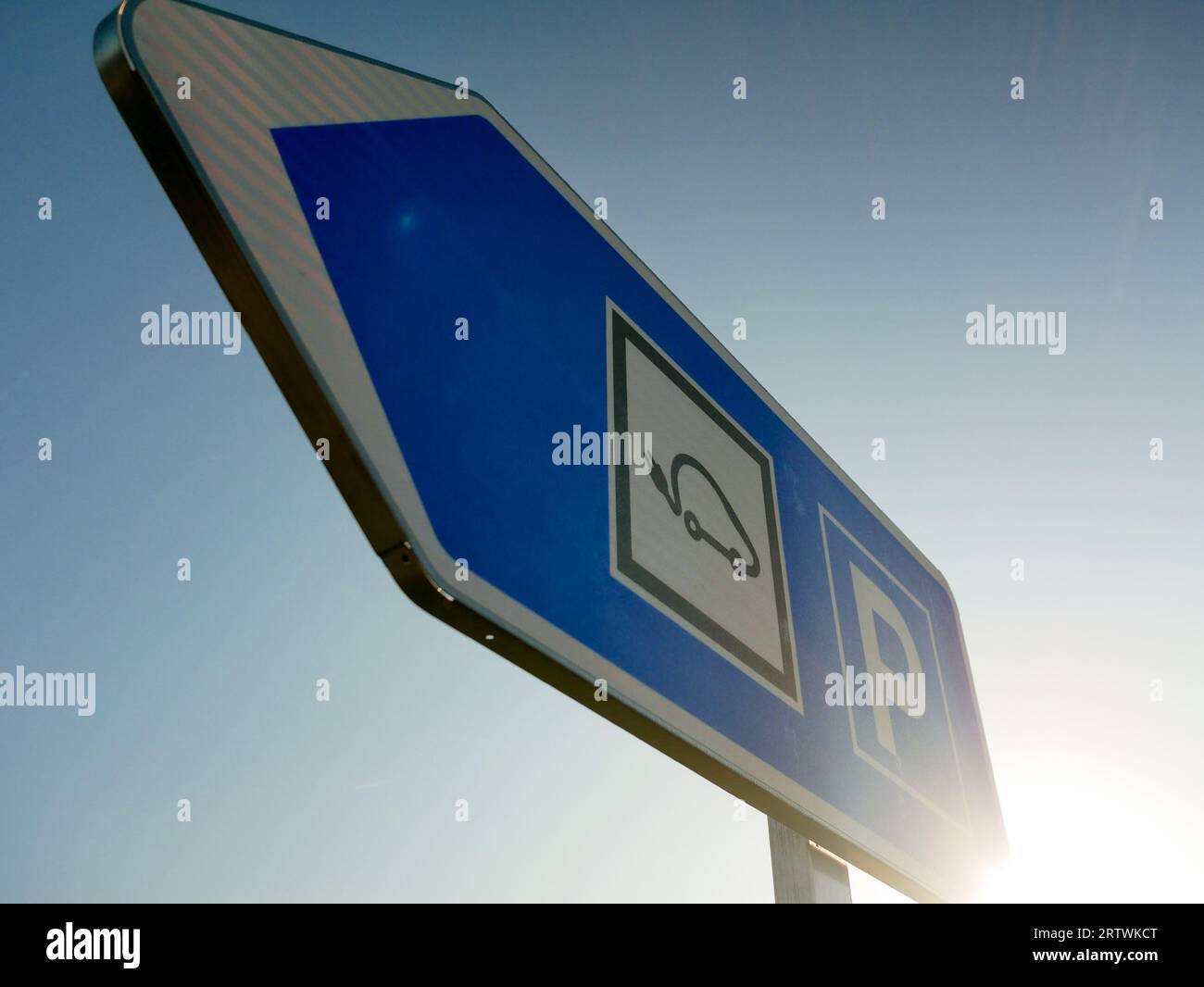 Electric vehicle charger arrow on outdoor parking, concept of high