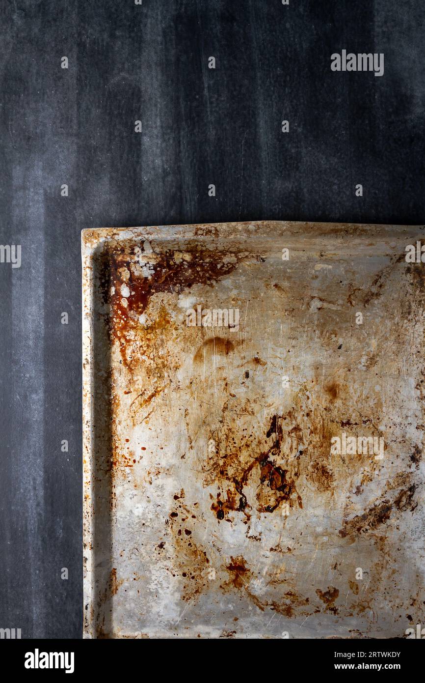 Used oven flat baking pan with burned spots and scratches on black