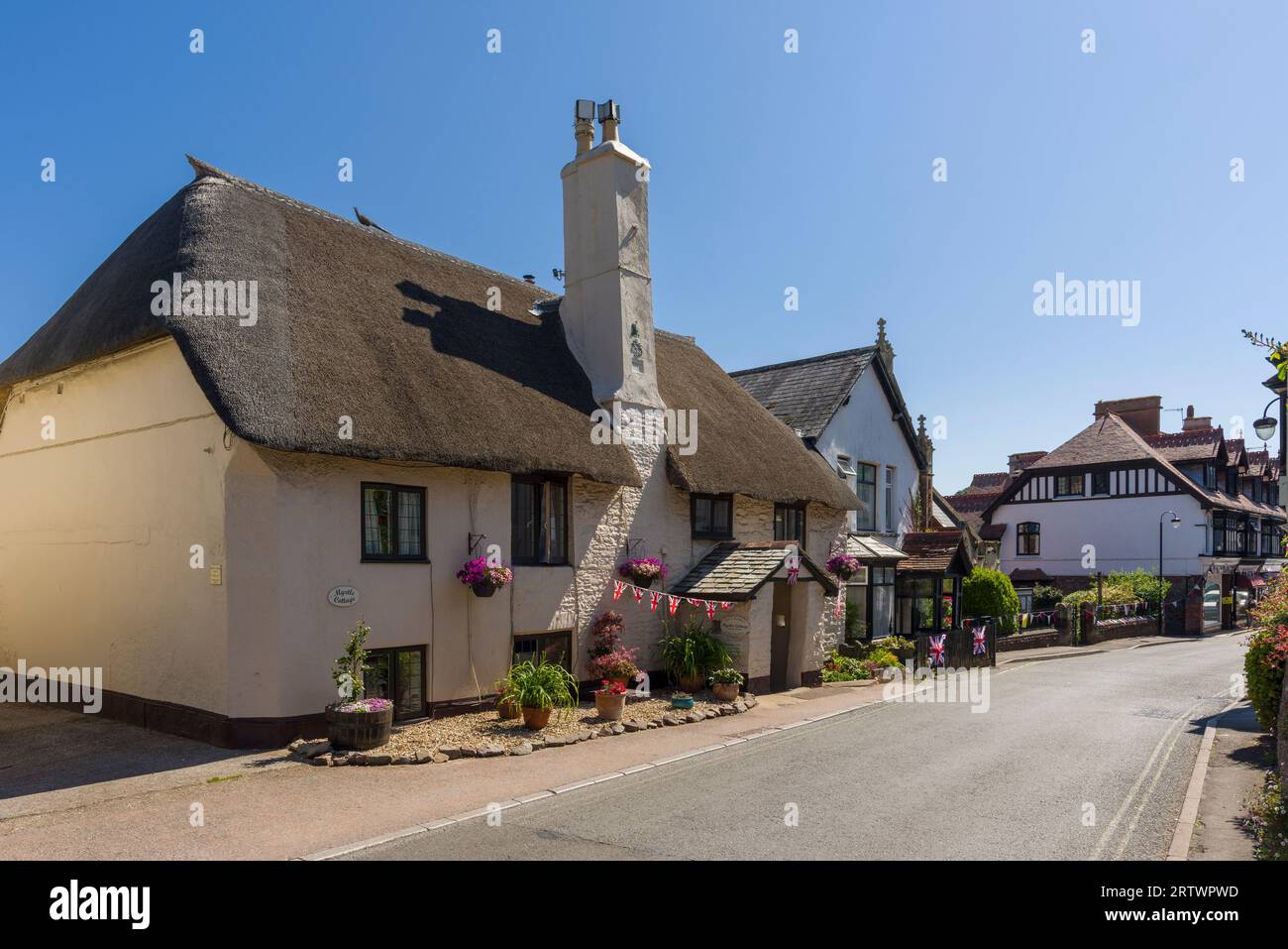 A thatched cottage on the High Street in the village of Porlock, Exmoor National Park, Somerset, England. Stock Photo