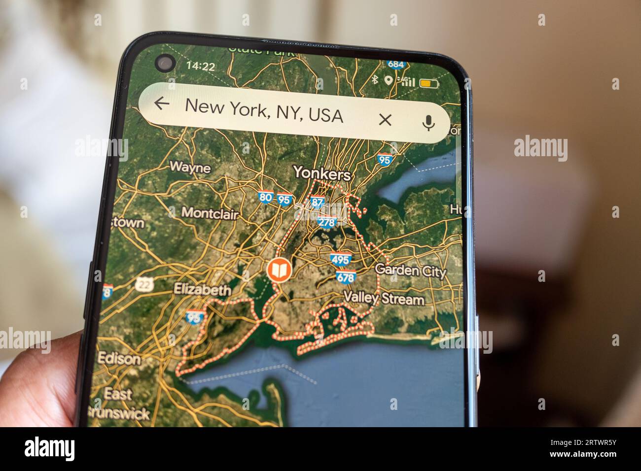 Madrid, Spain 09 14 2023: Screen of a mobile phone with the map of New York city on the Google Maps app. Stock Photo
