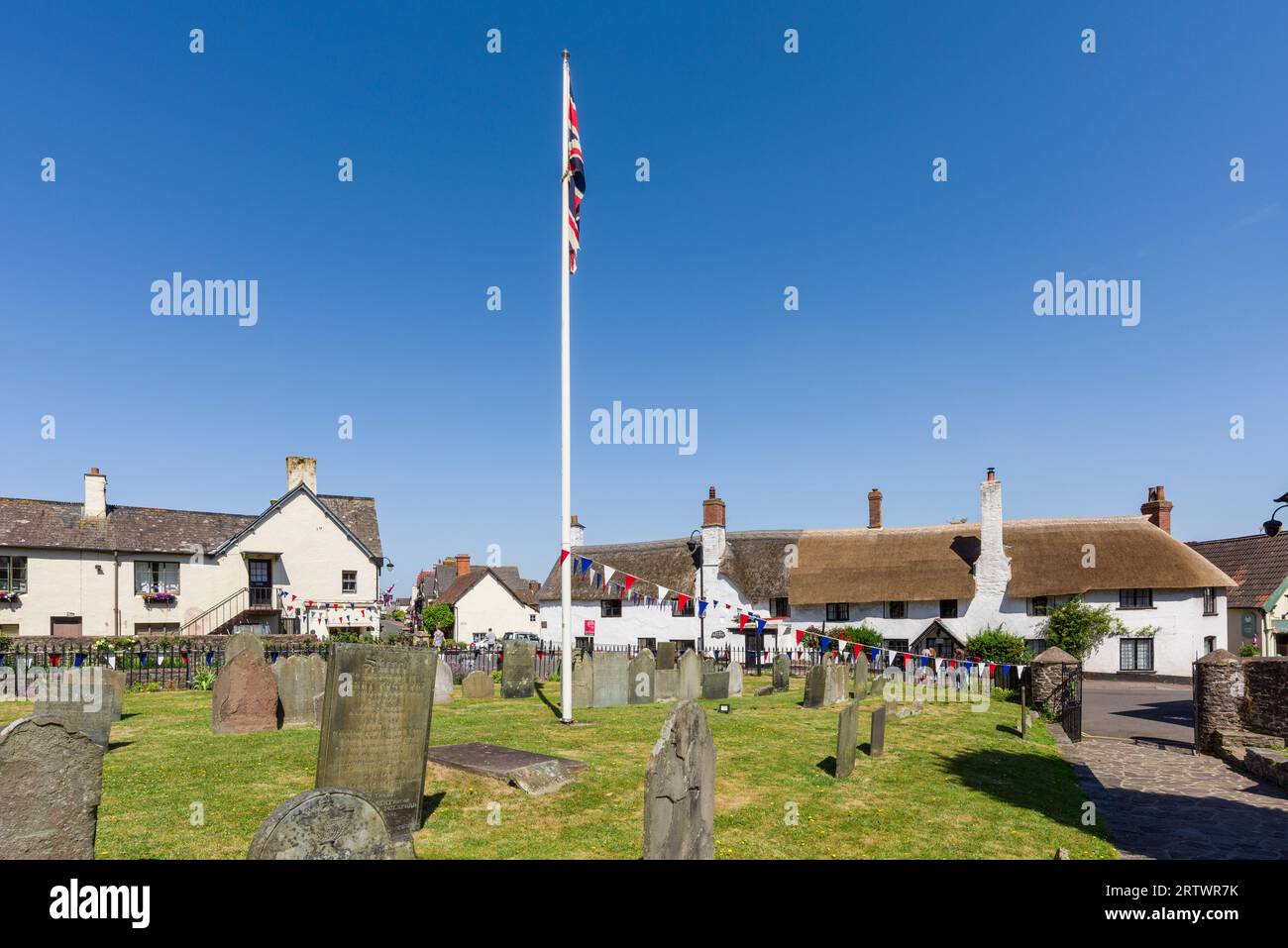 The churchyard of the Church of St Dubricius overlooking the hight Street in the village of Porlock, Exmoor National Park, Somerset, England. Stock Photo
