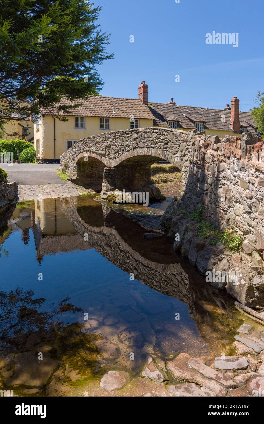 Allerford Bridge, a medieval packhorse bridge over the Aller river at Allerford in the Exmoor National Park, Somerset, England. Stock Photo