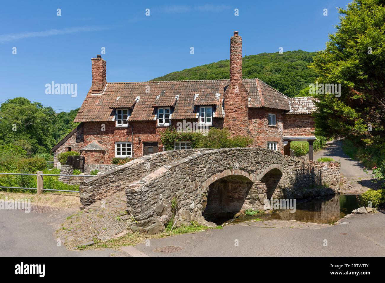 Allerford Bridge, a medieval packhorse bridge over the Aller river at Allerford in the Exmoor National Park, Somerset, England. Stock Photo