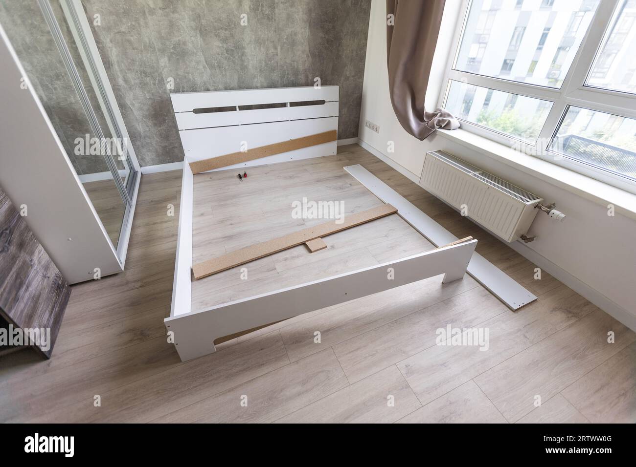 The furniture assembler assembles the bed frame, do it yourself and