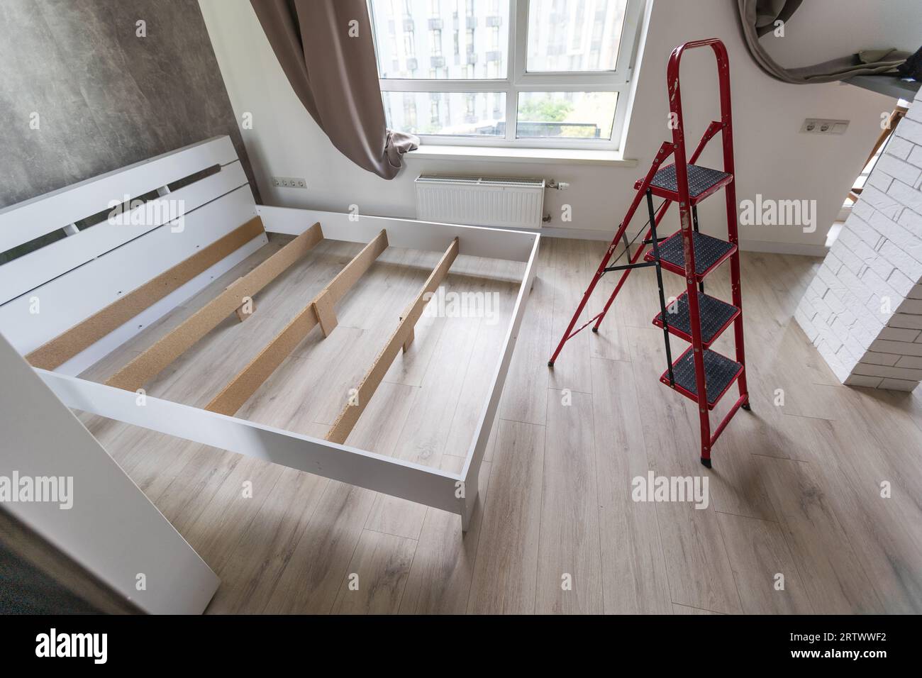 The furniture assembler assembles the bed frame, do it yourself and