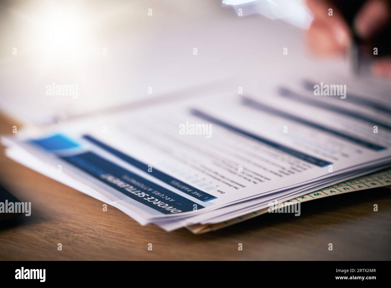 Person, hands and writing on divorce documents, application or information on table or office desk. Closeup of partner signing legal paperwork Stock Photo