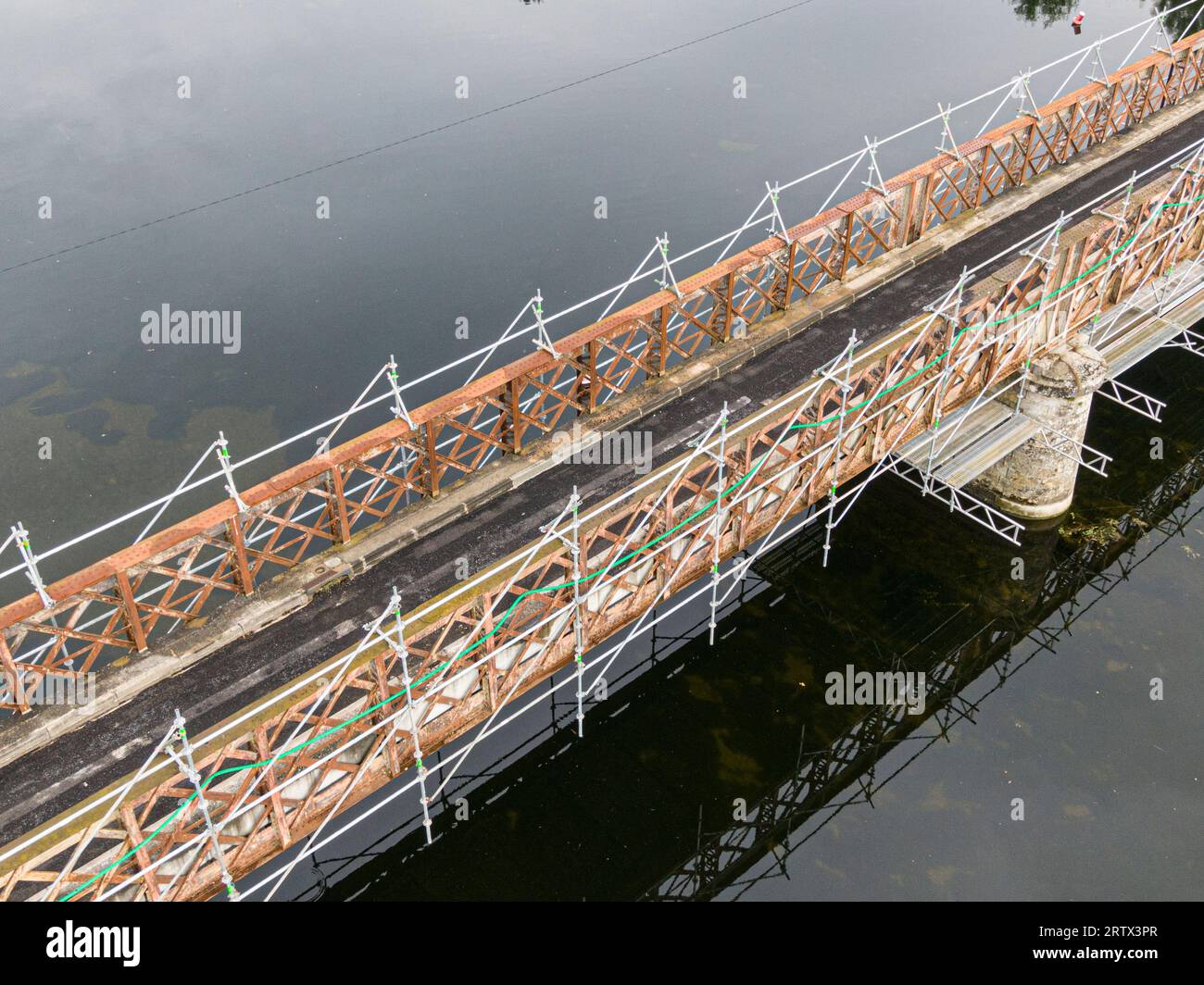 Scaffolding used for maintenance or restoration work on a small bridge over a large river the Cher Stock Photo