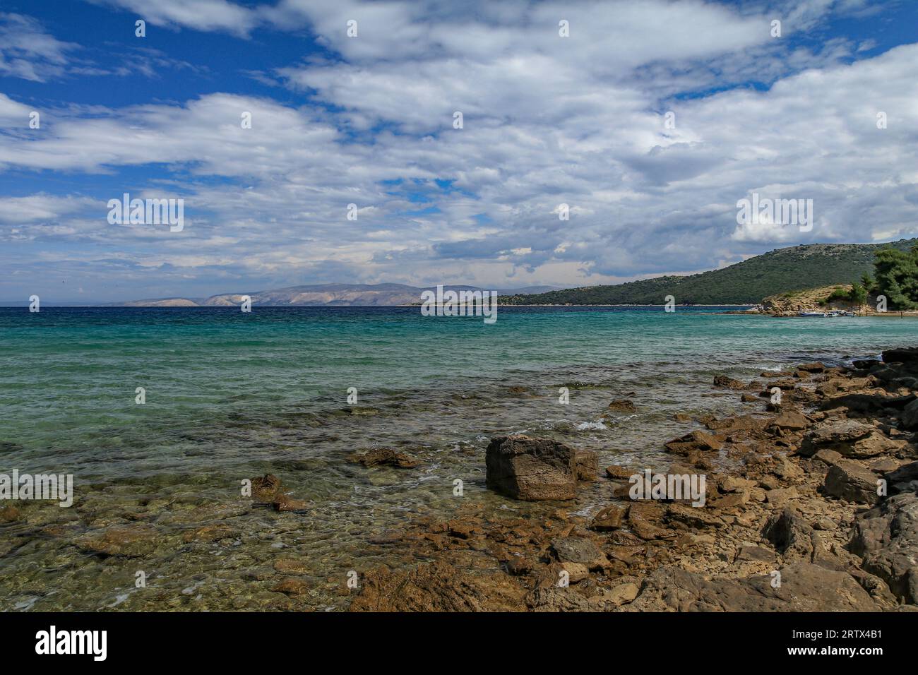The blue Adriatic Sea, the stony shore of the island of Rab in Croatia Stock Photo