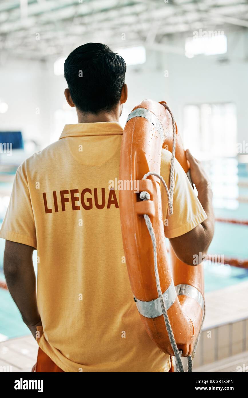 Swimming pool lifeguard and person with lifebuoy safety equipment and watch for rescue support