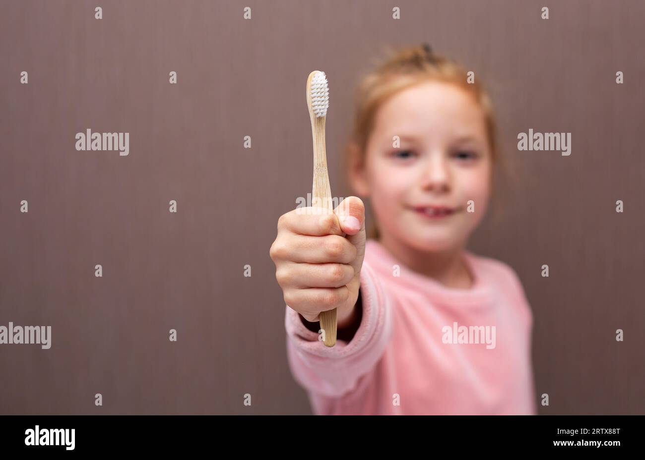 Little girl brushing her teeth. Girl with a toothbrush. Oral hygiene. Stock Photo