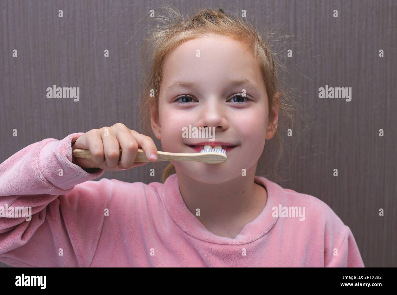 Little girl brushing her teeth. Girl with a toothbrush. Oral hygiene. Stock Photo