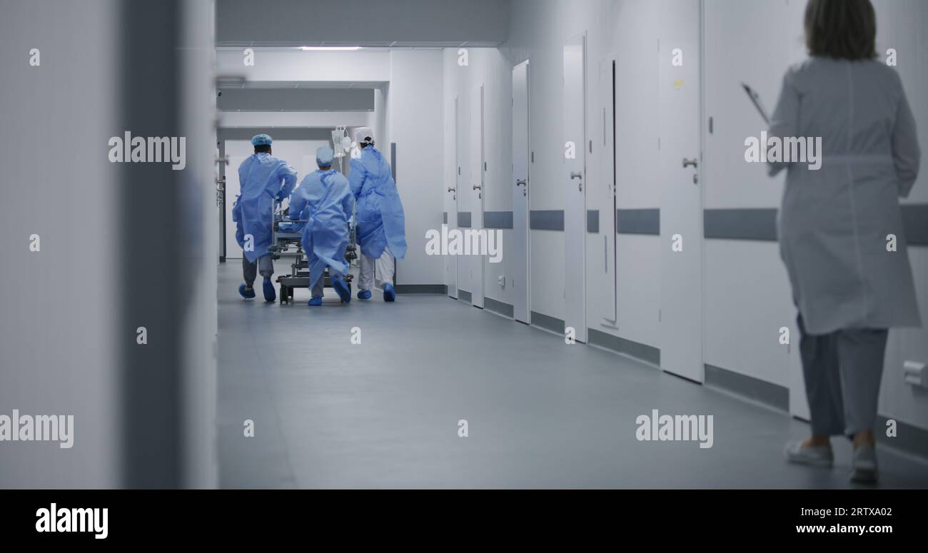 Doctors, nurses and paramedics push stretcher with patient to surgery