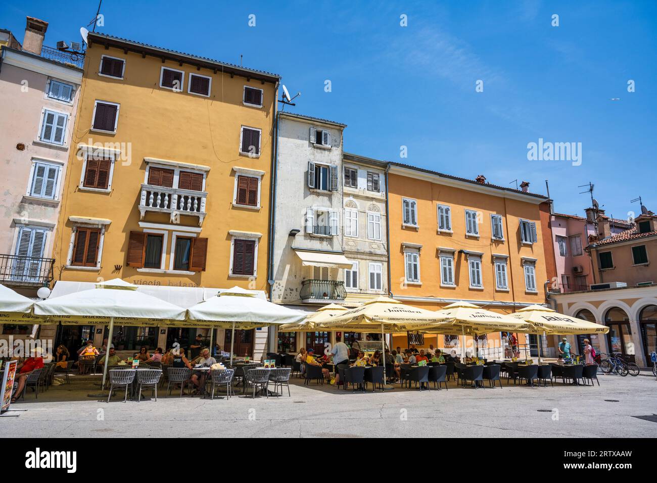 Outdoor cafes and restaurants on Marshal Tito Square in the old town of Rovinj on the Istrian Peninsula of Croatia Stock Photo