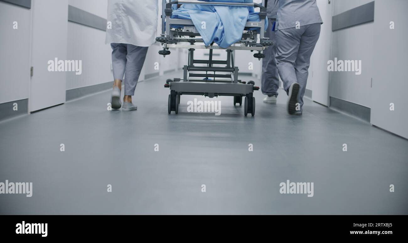 Doctors and paramedics move gurney with seriously injured patient