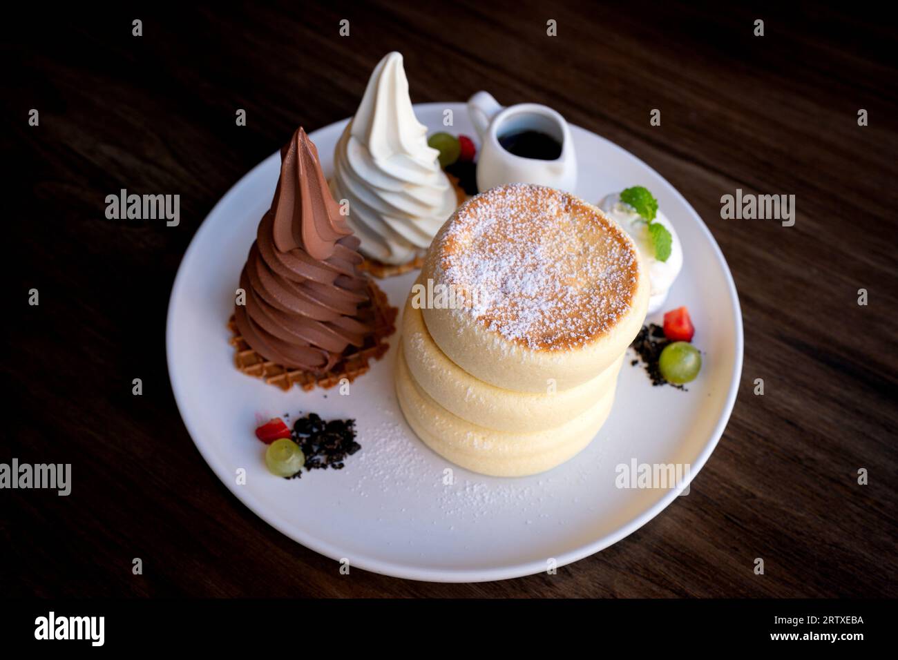 Closeup fluffy soufflé pancakes with chocolate and vanilla ice cream