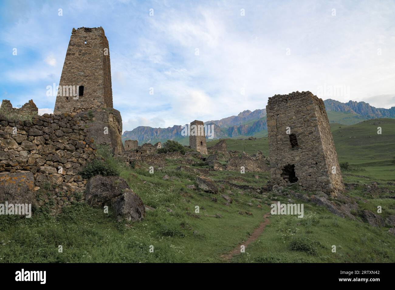 Ancient Ossetian defensive towers on the ruins of the village of Tsmiti on a early June morning. Northern Ossetia-Alania. Russian Federation Stock Photo
