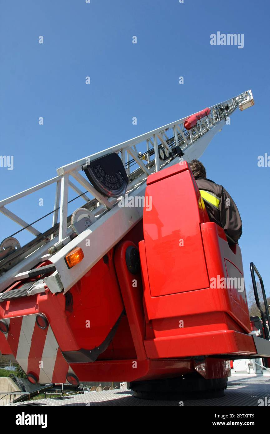 Long metal ladder of the ladder truck of the red fire truck during
