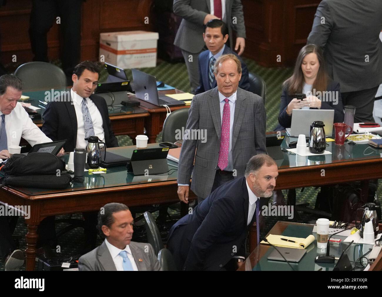 Suspended attorney general KEN PAXTON enters the Senate floor among his attorneys as both sides have rested in Texas Attorney General Ken Paxton's impeachment trial in the Texas Senate on September 15, 2023. THe charges will go to the jury today. At left is Texas Ranger David Maxwell. Next to his is Ryan     . Credit: Bob Daemmrich/Alamy Live News Stock Photo