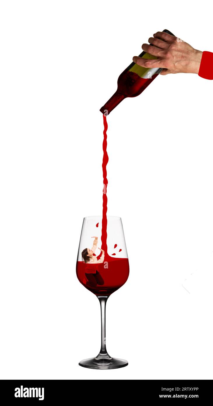 Young woman diving into glass with red wine. Human hand pouring wine. Female alcoholism and