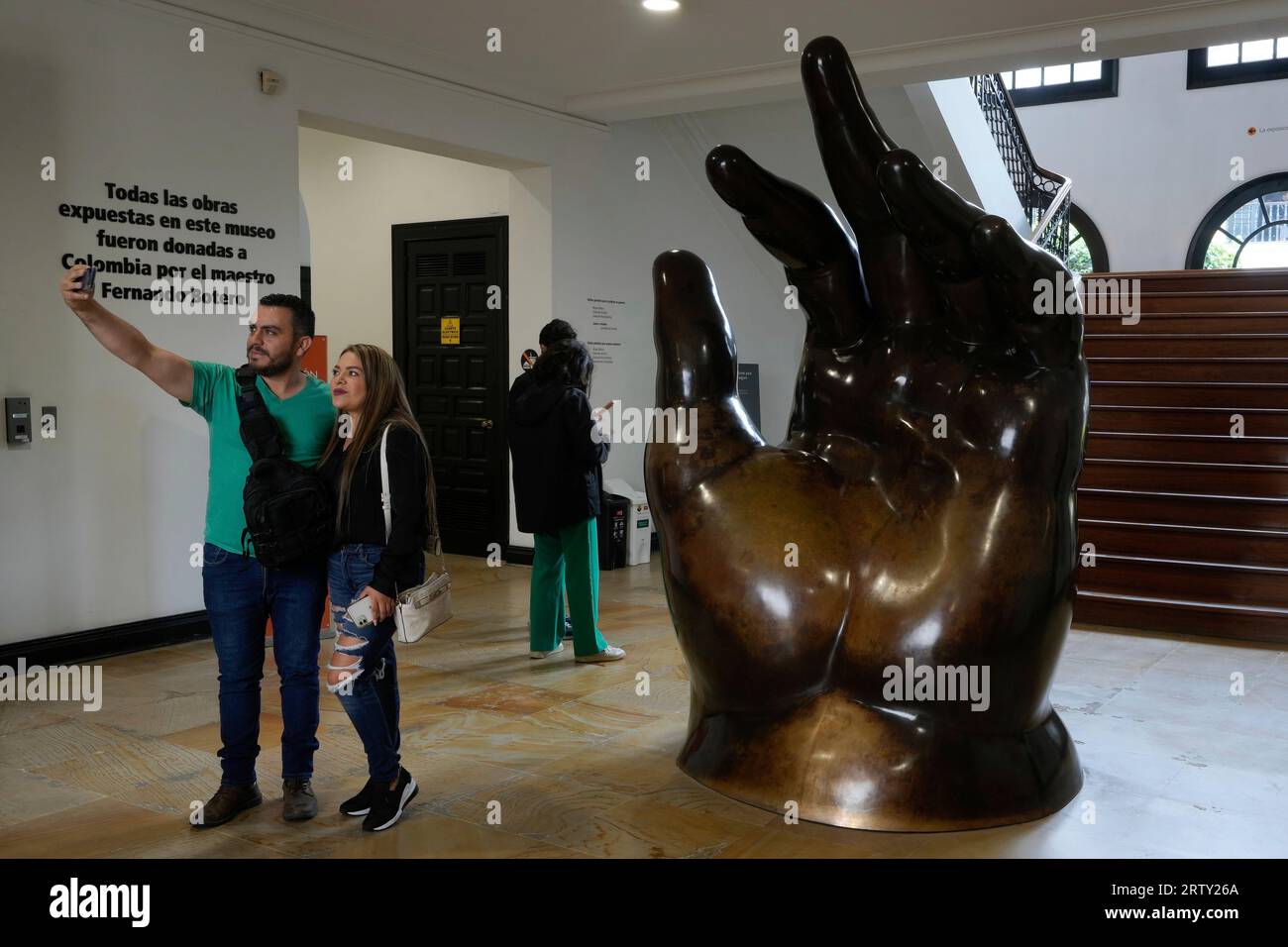 People take a selfie in front of the sculpture by Colombian artist ...