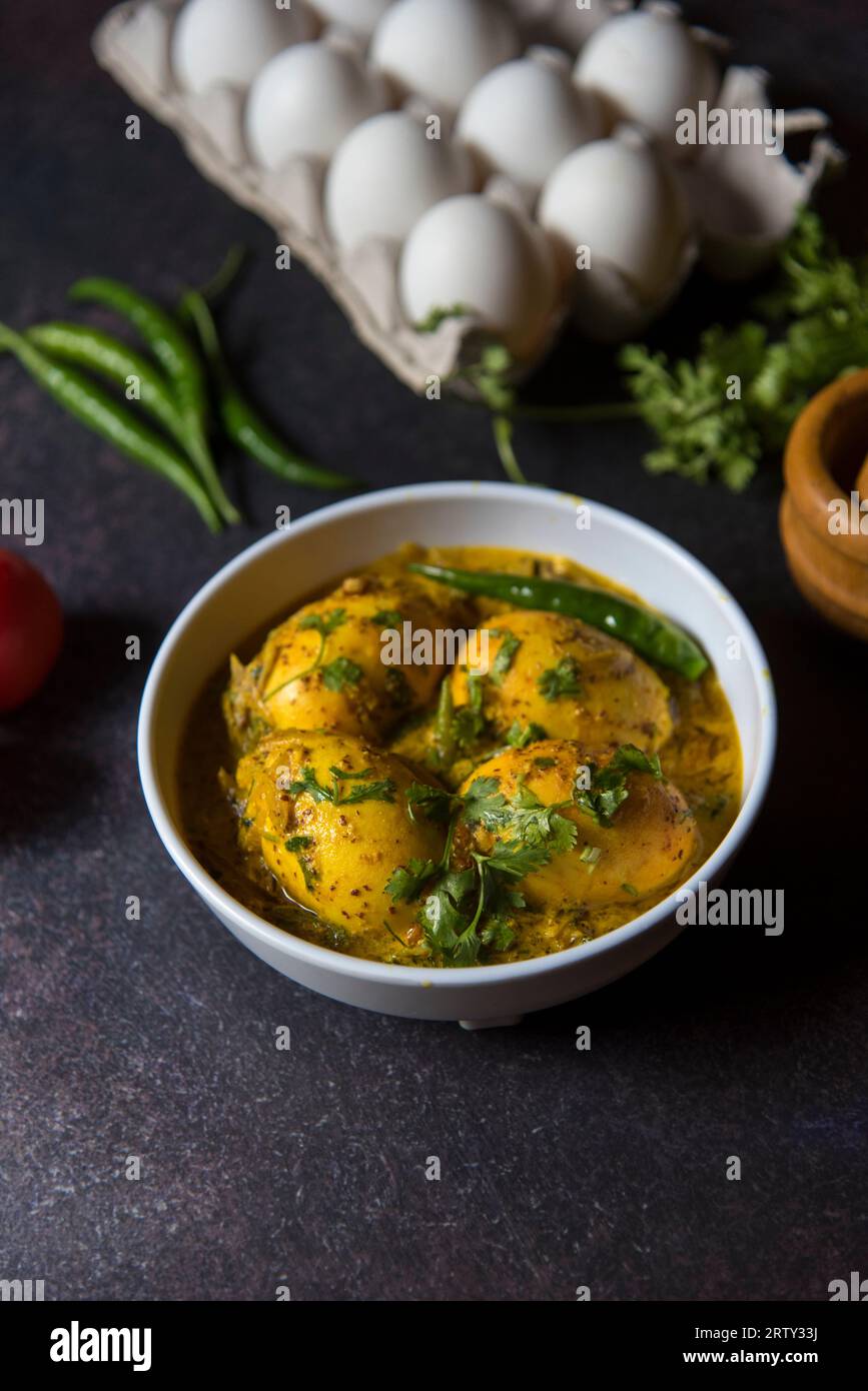 Indian style egg masala in mustard sauce served in a bowl. Close up, selective focus. Stock Photo