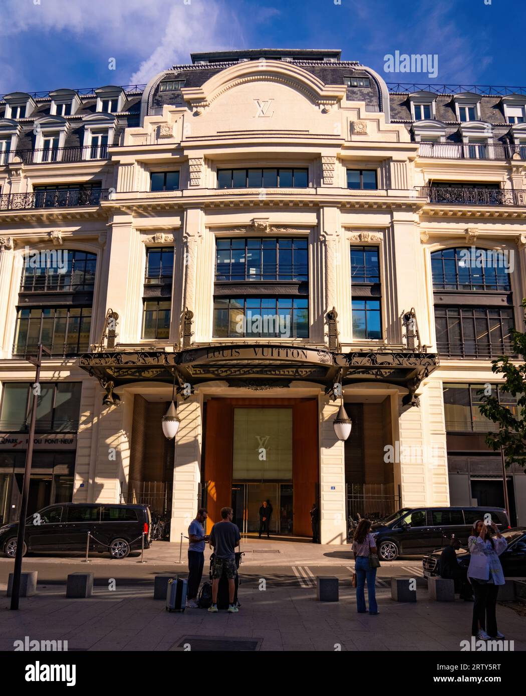 Paris. 11th May, 2020. Customers wearing protective face masks queue outside  the Louis Vuitton store before its reopening on the Champs Elysee avenue in  Paris, France on May 11, 2020. France started