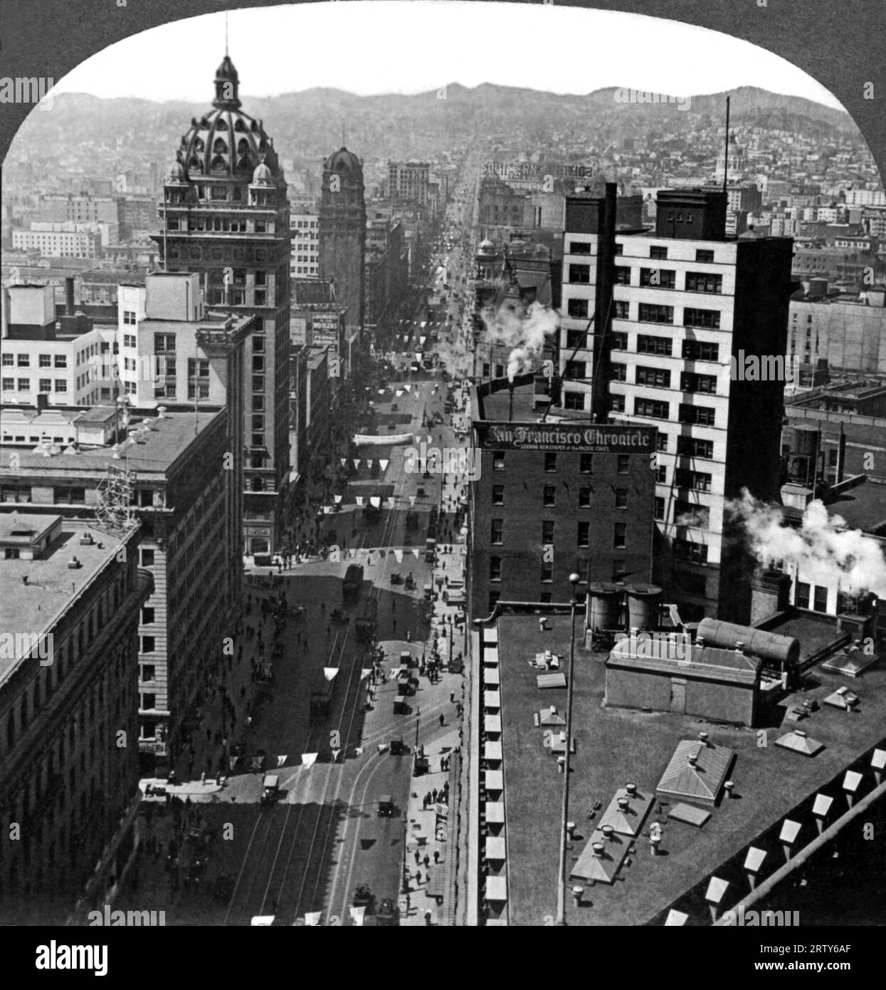 San Francisco, California   c. 1910.  Market Street in San Francisco, with the Call Building at left. Designed by noted local architects James and Merritt Reid along with bridge engineer Charles Strobe, the structure survived the 1906 earthquake. Eighteen stories tall, it was San Francisco's first sksyscraper and the tallest building west of Chicago. Stock Photo