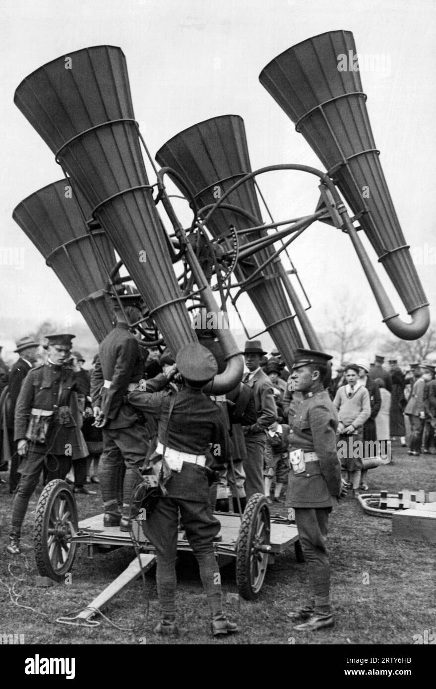 United States   April 2, 1925 Troops inspecting a newly-developed acoustic locator device, mounted on a wheeled platform. The large horns amplify the distant sounds of approaching enemy aircraft, enabling the aircraft defenders to derive their distance and altitude. Stock Photo