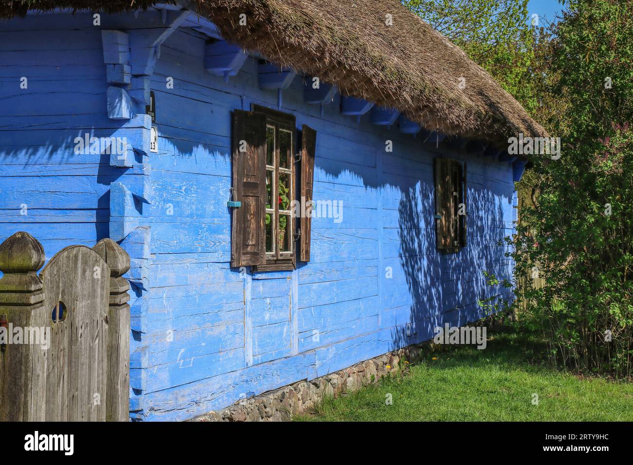 Old wooden blue country house with thatched roof Stock Photo - Alamy