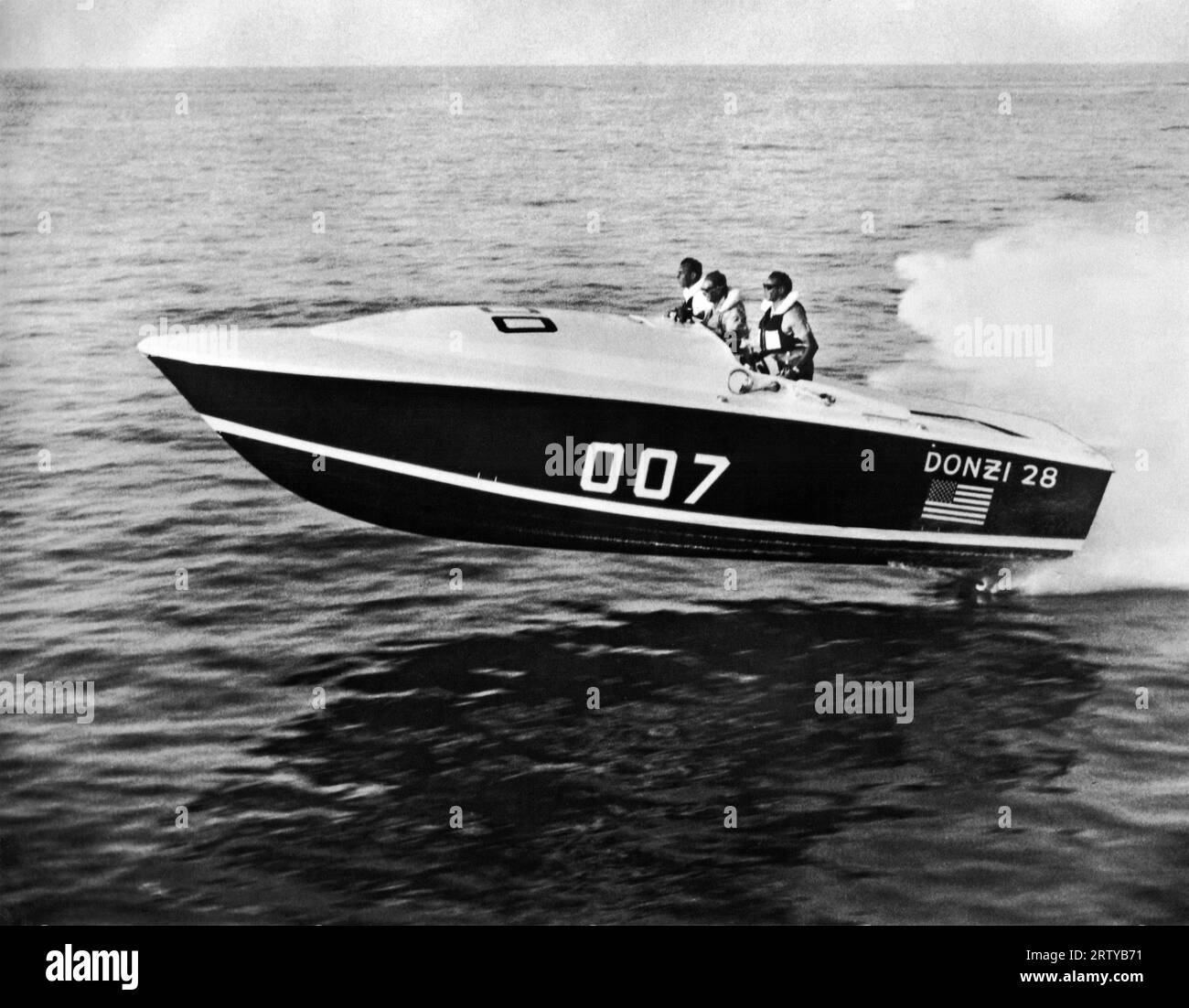 West Palm Beach, Florida     April, 1965 Owner and builder Don Aronow of Miami pilots his 28 foot Donzi in which he won the 184 mile Miami-Nassau ocean race this year. It runs at 70 mph with twin 427 cubic-inch Holman-Moody Ford engines, each rated at 500 horsepower. Stock Photo