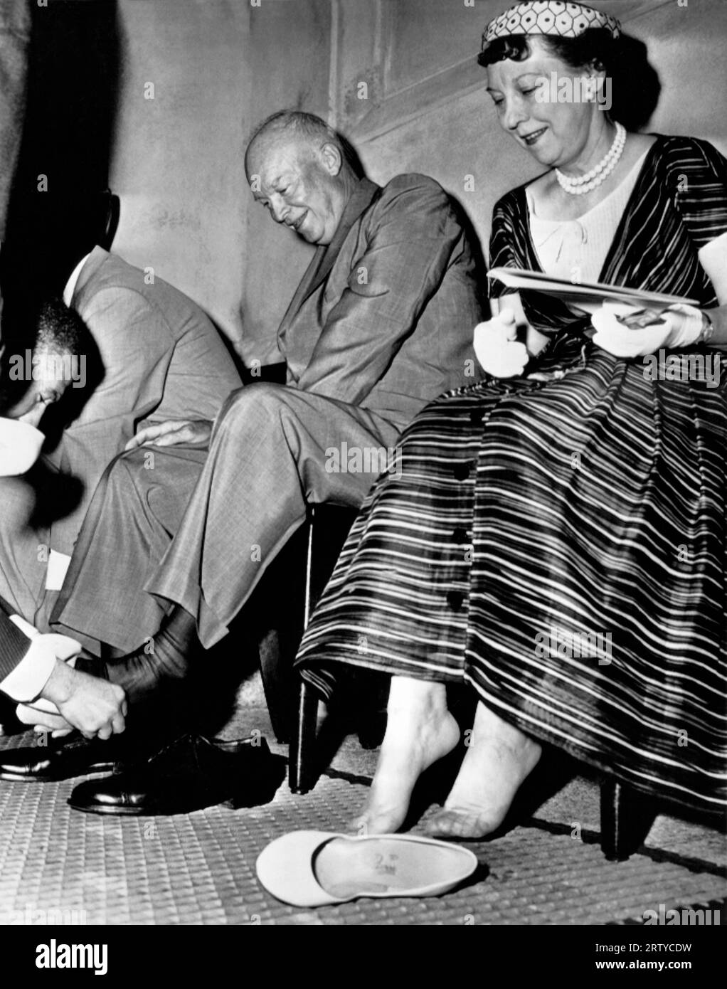 Washington, D.C.  June 28, 1957. President Eisenhower and the First Lady conform to Moslem custom and remove their shoes for a tour of the new Islamic mosque which they helped to dedicate here today, Stock Photo
