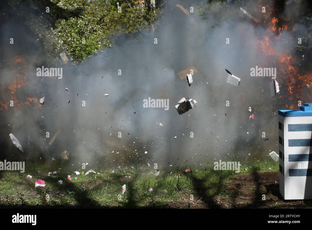 Fire from a large explosion between green trees Stock Photo - Alamy
