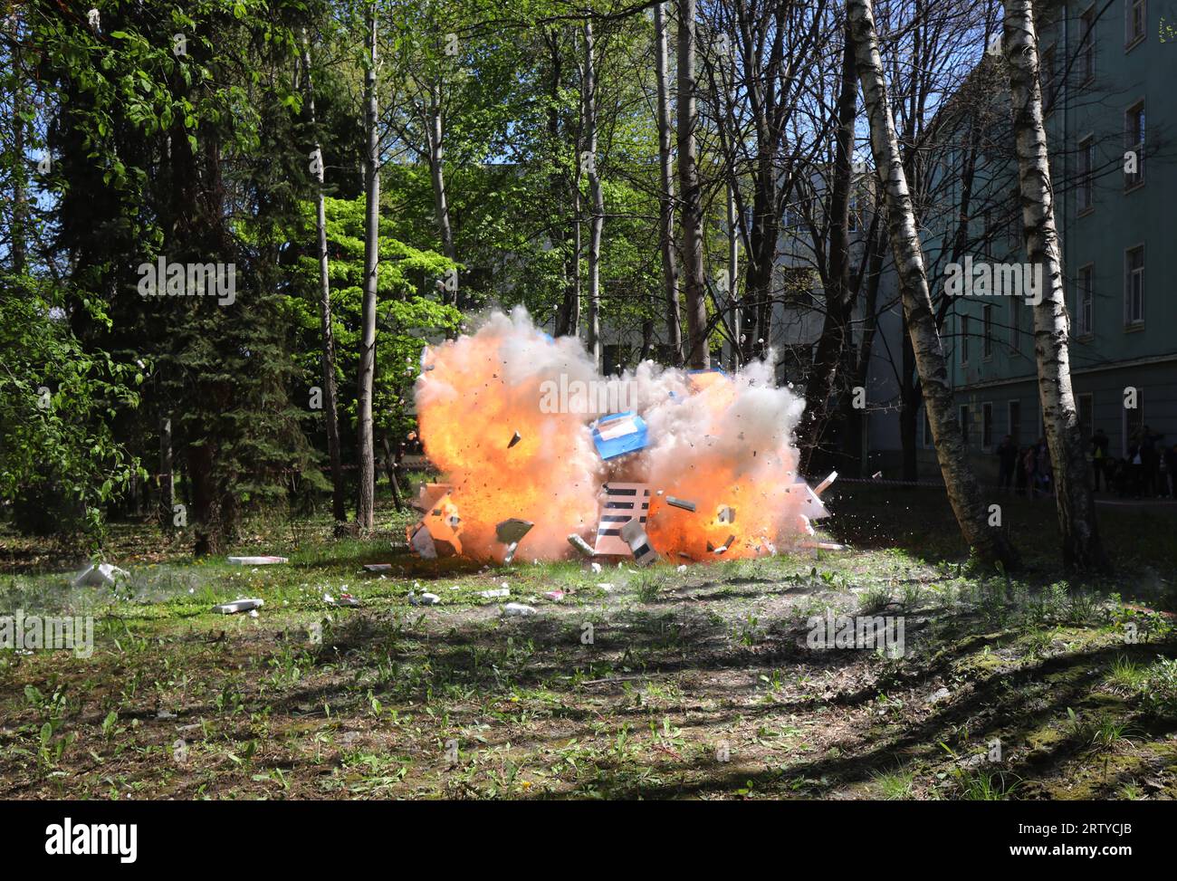 Fire from a large explosion between green trees Stock Photo - Alamy