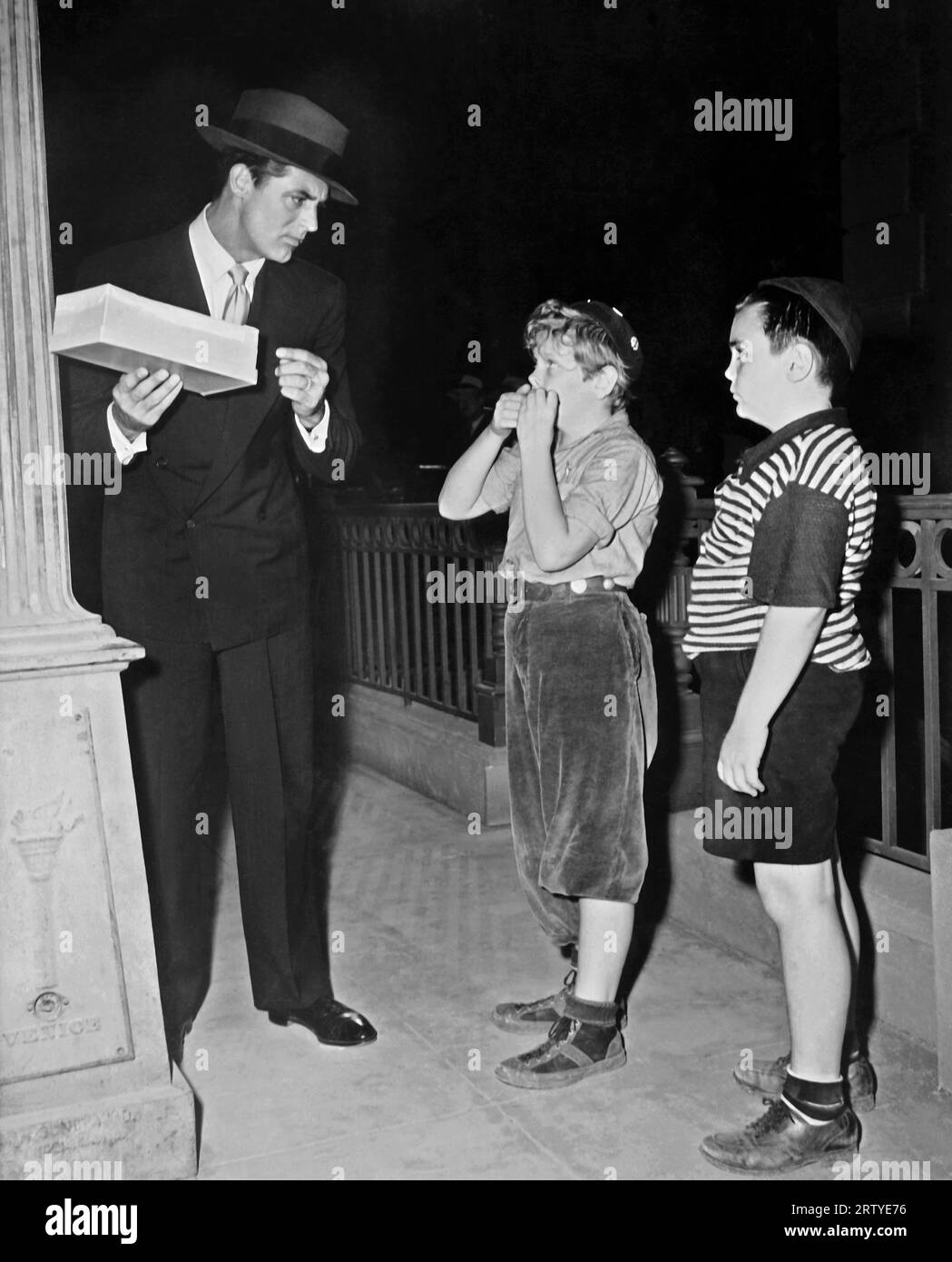 Hollywood, California    1944 Actors Cary Grant, Ted Donaldson and Mickey McGuire in the Columbia film, 'Once Upon a Time'. Stock Photo