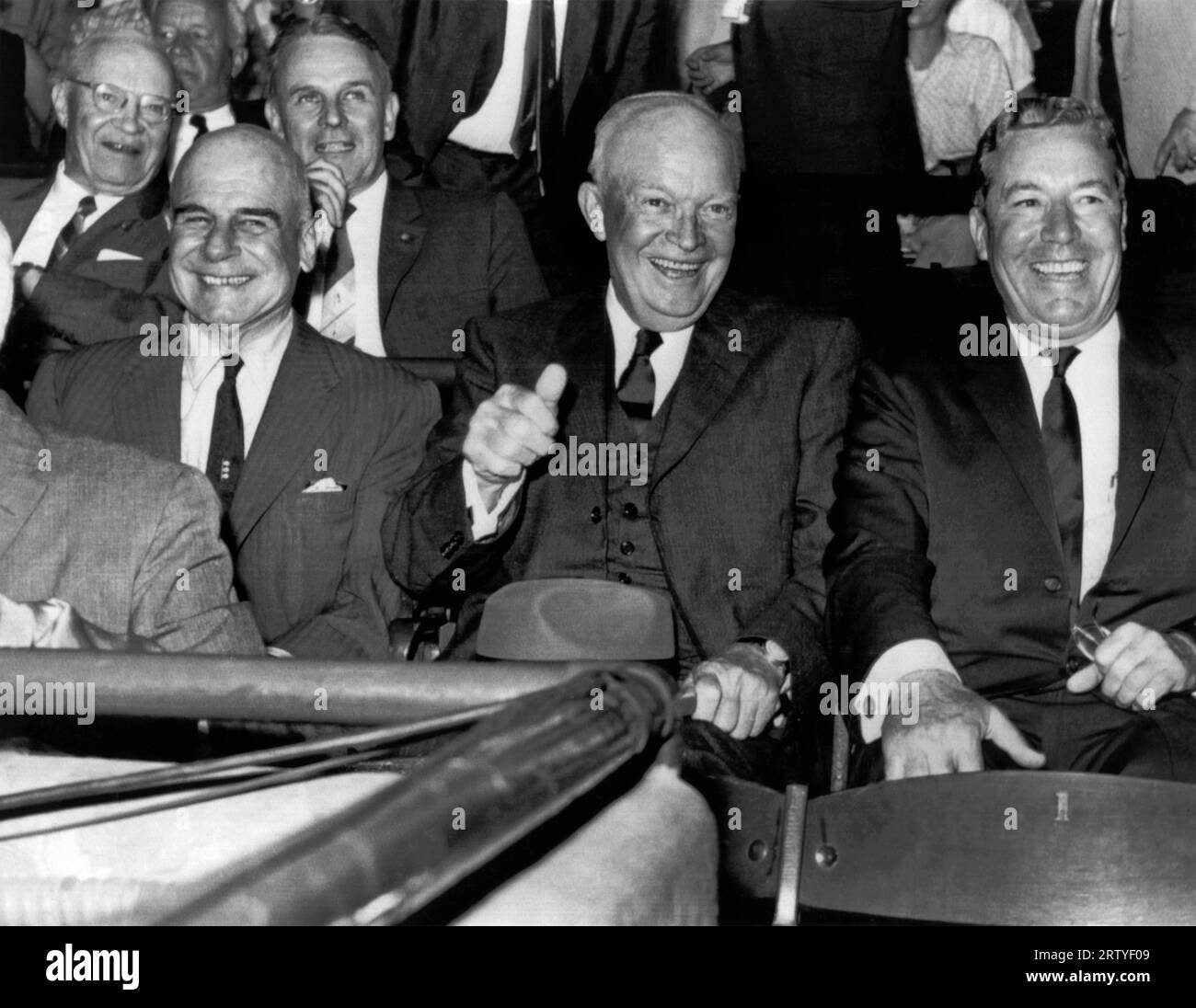 Washington, D.C.   June 6, 1961 D-Day participants attend the Washington-Cleveland baseball game on the anniversary of D-Day. Front row, L-R, is General Jimmy Doolittle, Dwight Eisenhower, and E.R. Quesada, president of the Washington Senators. General Maxwell Taylor is in back of and betweem Doolittle and Eisenhower. Stock Photo