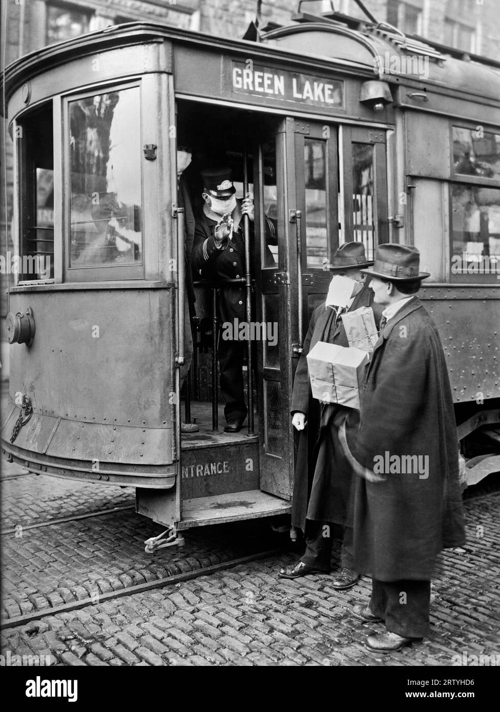 Seattle, Washington  c 1918 In Seattle, during the Spanish Influenza epidemic, street cars would not allow passengers to board without wearing a mask. Stock Photo