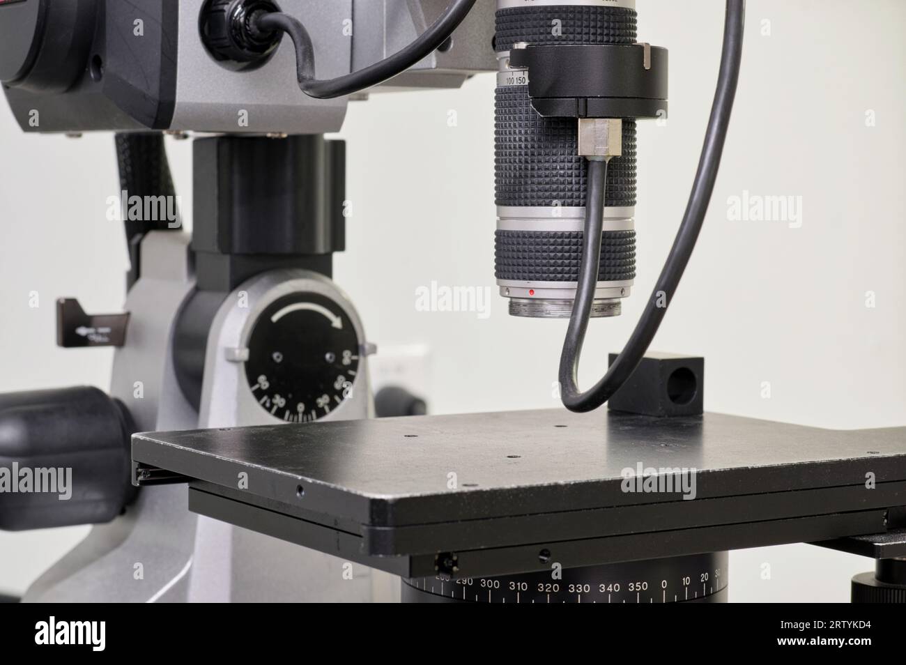 Digital microscope in a laboratory with selective focus on the lens. Isolated science and research lab equipment with no people. Stock Photo