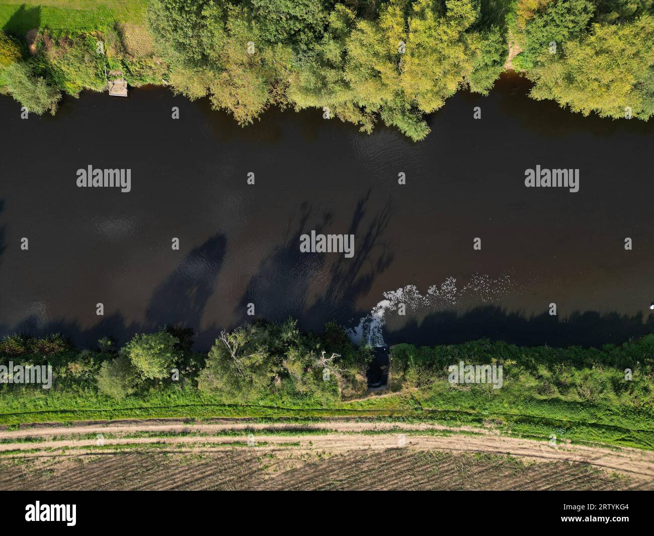 Effluent discharge into the River Wye at Rotherwas Hereford from a Welsh Water waste water sewage treatment farm - aerial view September 2023 Stock Photo