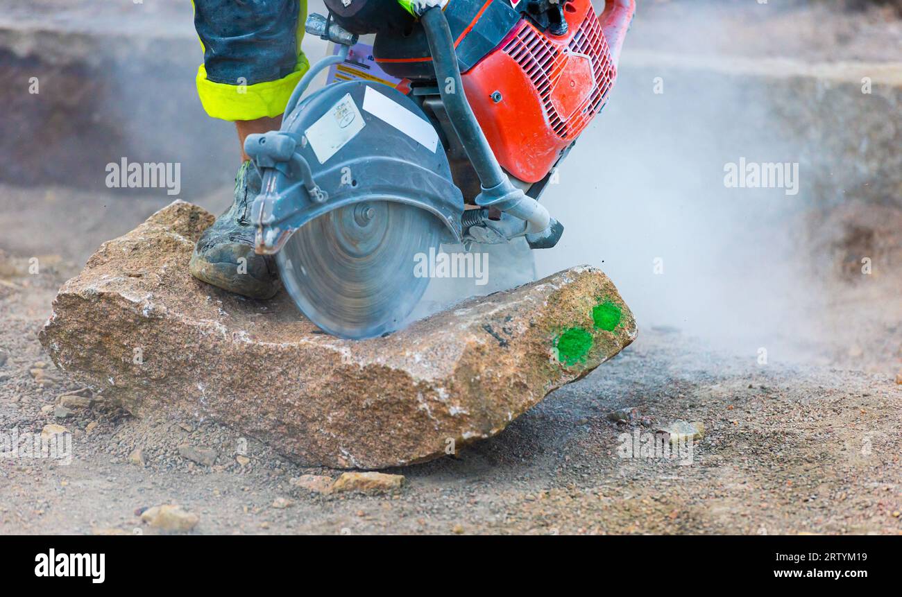 Person using a stone saw with diamond blade to cut a stone Stock Photo ...