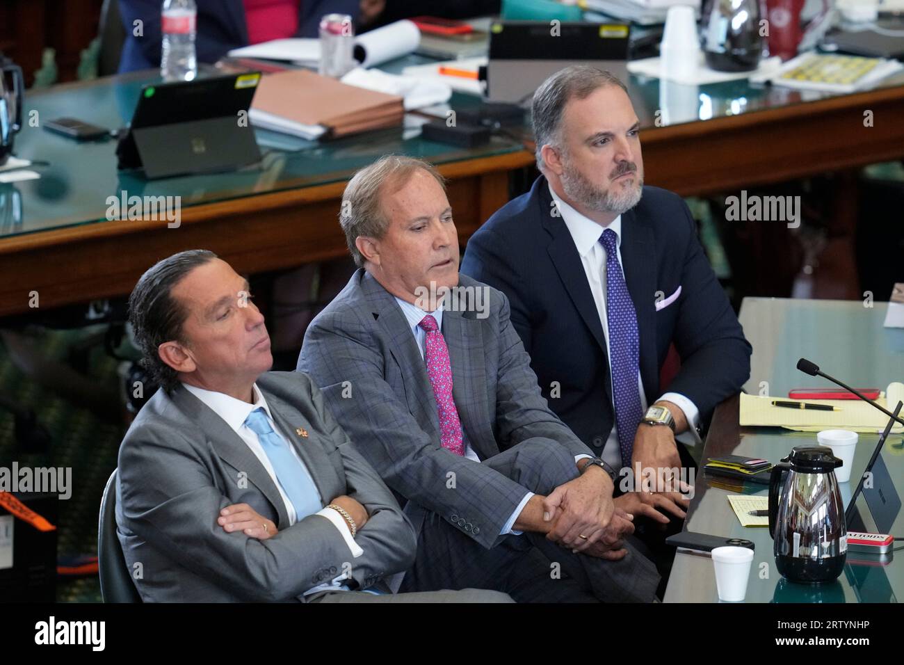 Suspended attorney general KEN PAXTON, c, sits between lawyers TONY BUZBEE, l, and MITCH LITTLE, r, during final arguments in Texas Attorney General Ken Paxton's impeachment trial in the Texas Senate on September 15, 2023. The jury is deliberating the charges late Friday afternoon. Credit: Bob Daemmrich/Alamy Live News Stock Photo
