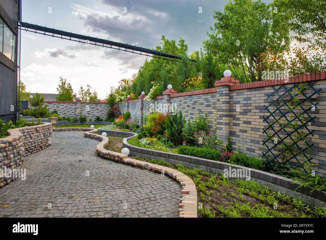 Inner yard garden behind a stone fence outdoor Stock Photo