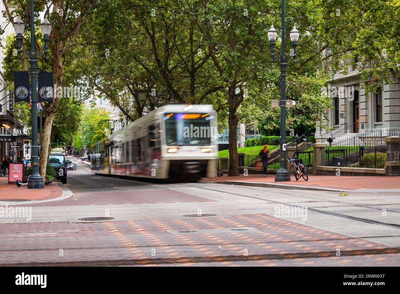 Trimet MAX train passing by the Pioneer Courthouse in downtown Portland Oregon Stock Photo