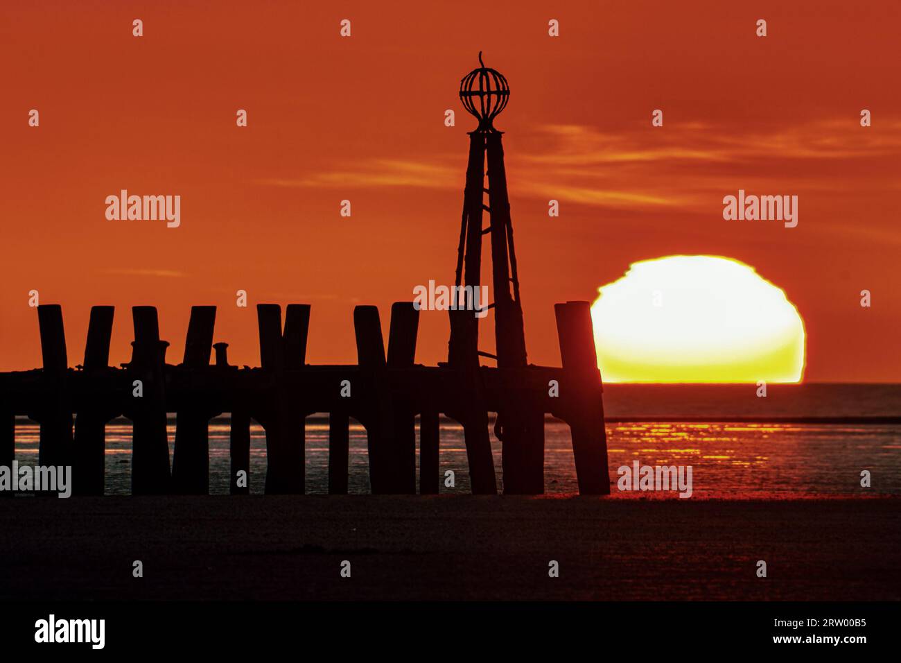 Silhouette of the Old Jetty at Sunset - Lytham St Annes Stock Photo