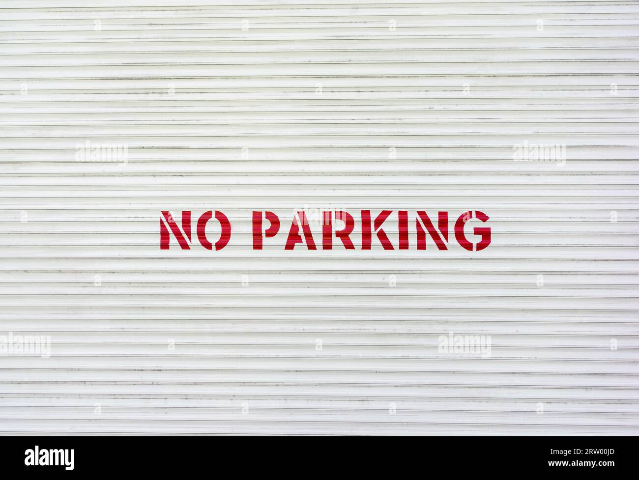 No Parking painted in red letters on a garage door, UK Stock Photo