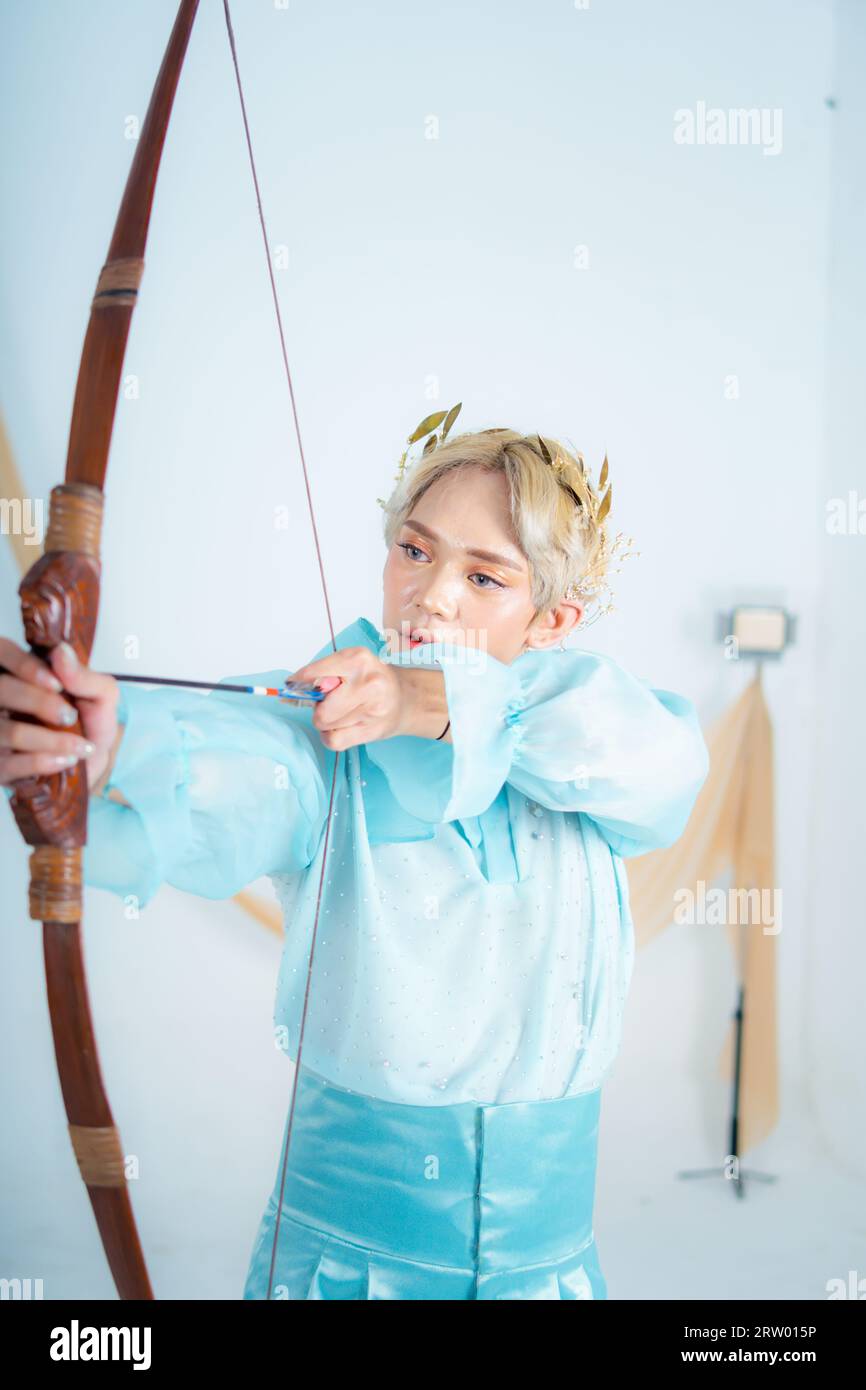 a princess in a blue dress pulling a bow with her hand in a white room ...