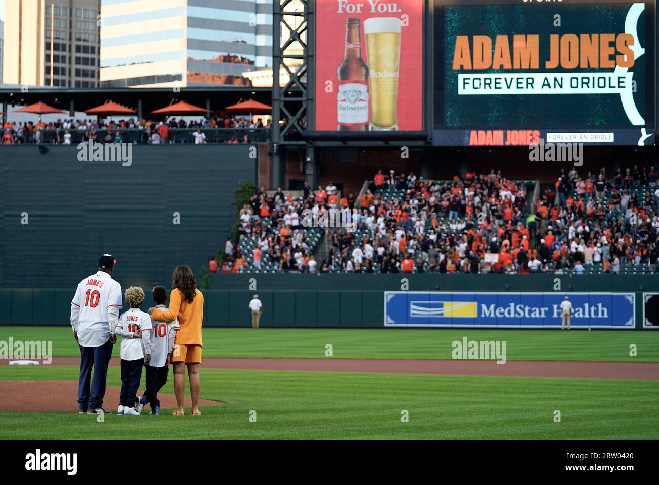 Former Baltimore Orioles player Adam Jones, left, stands on the